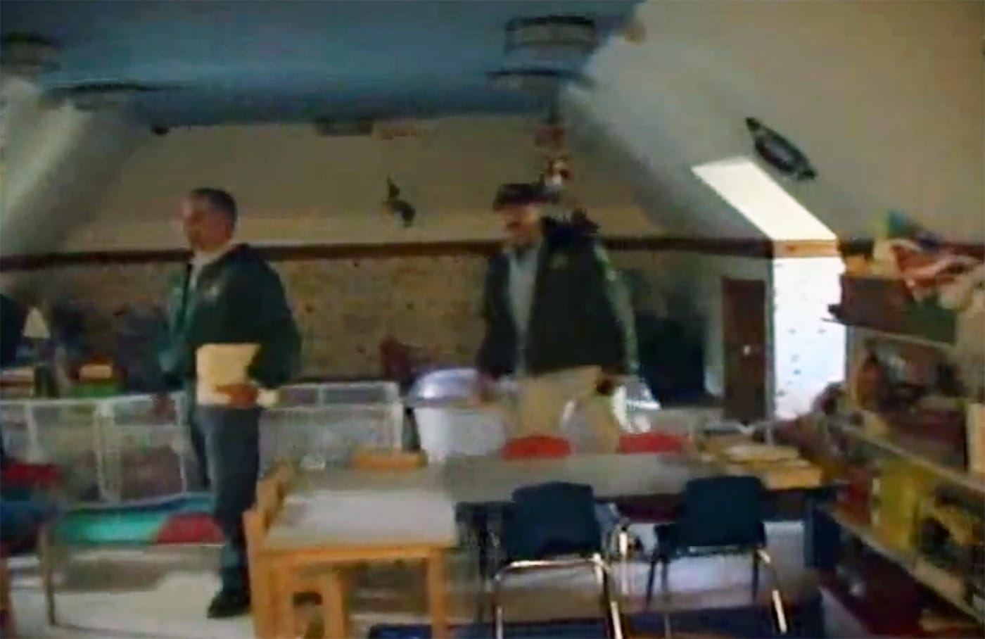 Members of the Santa Barbara Country Sheriff’s Department walking through Michael Jackson's Neverland Ranch during the 2003 police raid. (screenshot by the author)