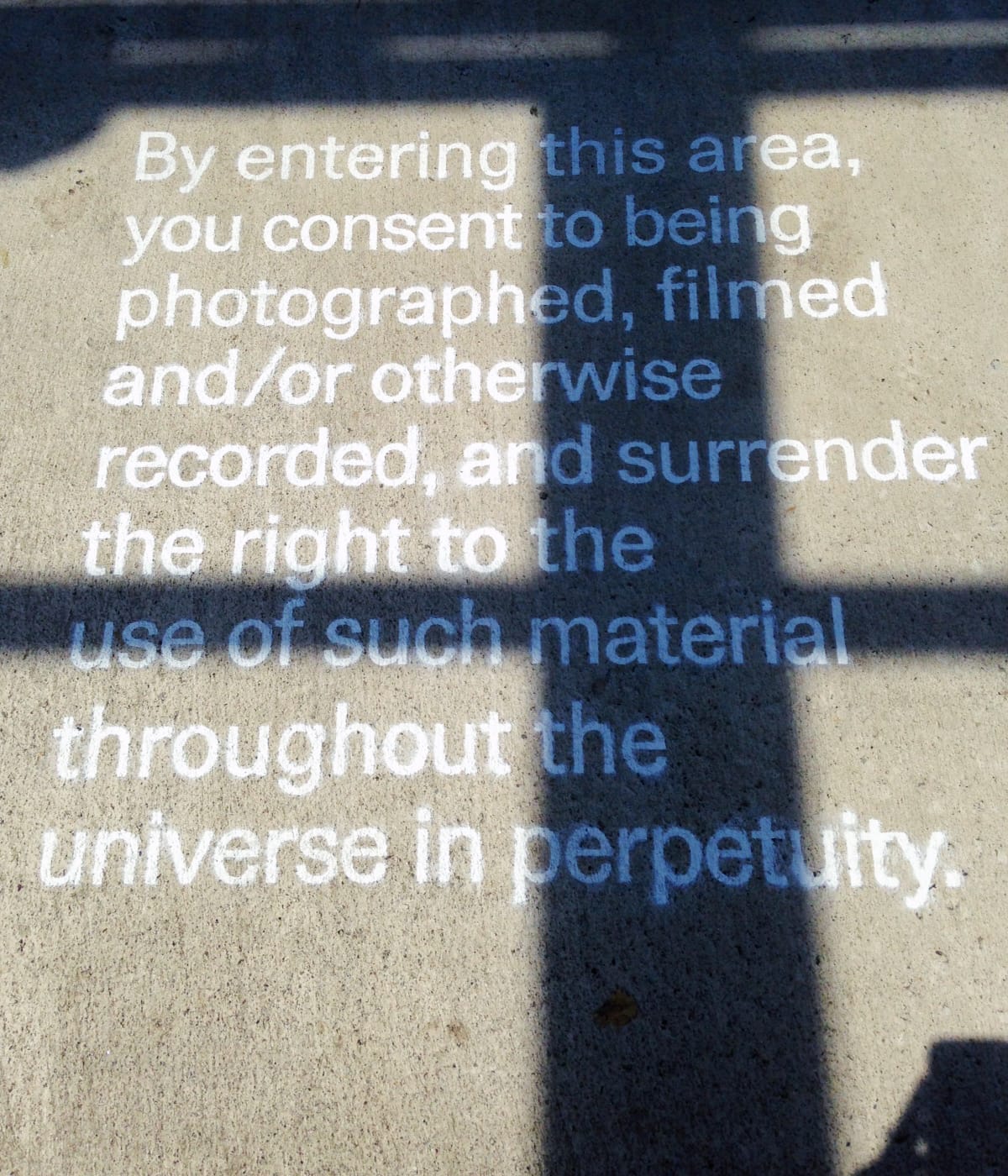 A disclaimer on the pavement outside the new International Center of Photography (photo by the author for Hyperallergic)
