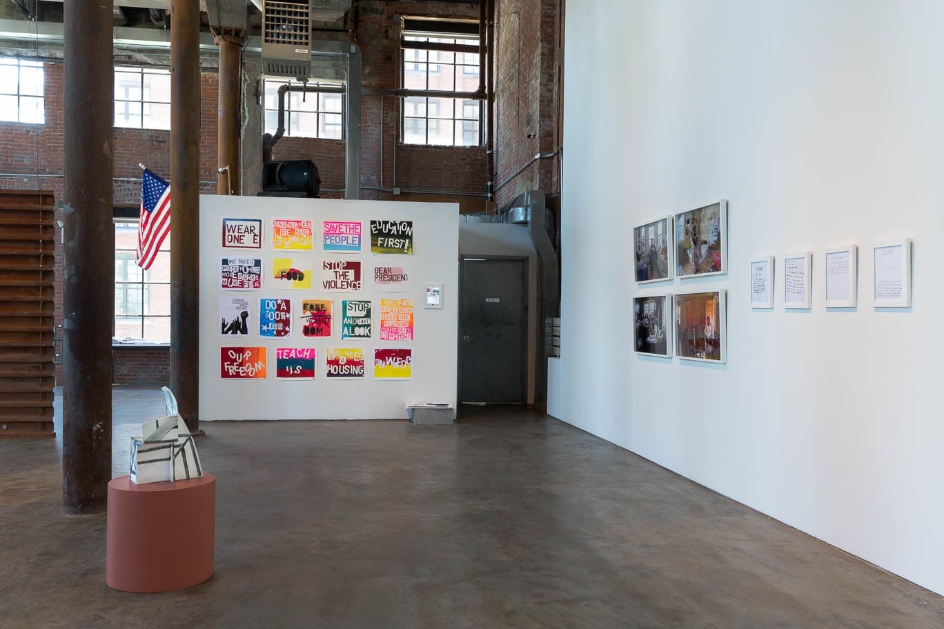 Installation view 1) Leah Wolff, Cantilevered Balcony, Clay and glaze, 19”x 13”x 9”. 2) t.Rutt (Mary Mihelic and David Gleeson), Desecration Flag, 2016. Flag, flagpole, thread. 3’ x 5’ plus 4’ flagpole and flagpole holder. Edition: 1 of 2. 3) Brooklyn Hi-Art Machine (Mildred Beltre and Oasa DuVerney) Dear President, All Mouths Need Feeding and Demand Universal Basic Income, 2016. Screen prints, dimensions variable. Participants: AJ, Akil, Alexandra, Amil, Crash, Pops, Rosa, Sigrid, Sophie, Ujju. (All courtesy of the artist. Image courtesy of Smack Mellon, Brooklyn, NY. Photo by Etienne Frossard) Courtesy of the artist. Image courtesy of Smack Mellon, Brooklyn, NY. Photo by Etienne Frossard)