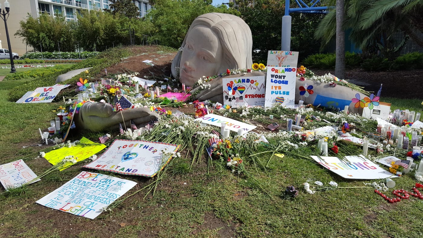 Lake Eola Park in Downtown Orlando on June 20, after the June 19 candlelight vigil. It was said that there were more than 20,000 people in attendance. Candles, flowers, and shrines were all around the lake, and in pockets all throughout the park. (photo by the author for Hyperallergic)