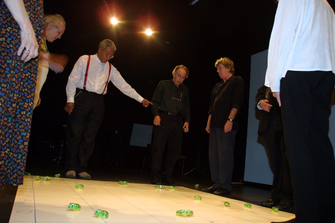 Benjamin Patterson (center) conducting his piece, "Pond" (1962), with (left to right) unknown, Philip Corner, Benjamin Patterson, Larry Miller, Eric Andersen, Ben Vautier (hands), Alison Knowles, in Odense, Denmark, on September 11, 2001. (photo by Dorte Krogh, courtesy the author)