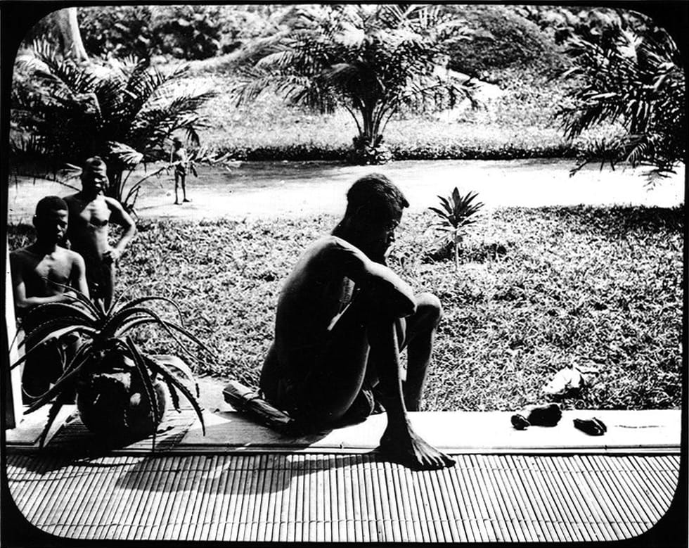 Alice Seeley Harris, a missionary stationed in the Congo Free State, took this photo of Nsala of Wala with the severed hand and foot of his five year-old daughter murdered by ABIR militia, a result of King Leopold of Belgium’s brutal colonial rule. This was all that remained of a cannibal feast following the murder of his wife, son and daughter. Harris documented the atrocities with a Kodak dry plate camera and shared these images in slideshows across Europe and the United States. Ndongo District, Congo Free State, c. 1904, Alice Seeley Harris, Courtesy Anti-Slavery International / Autograph ABP.