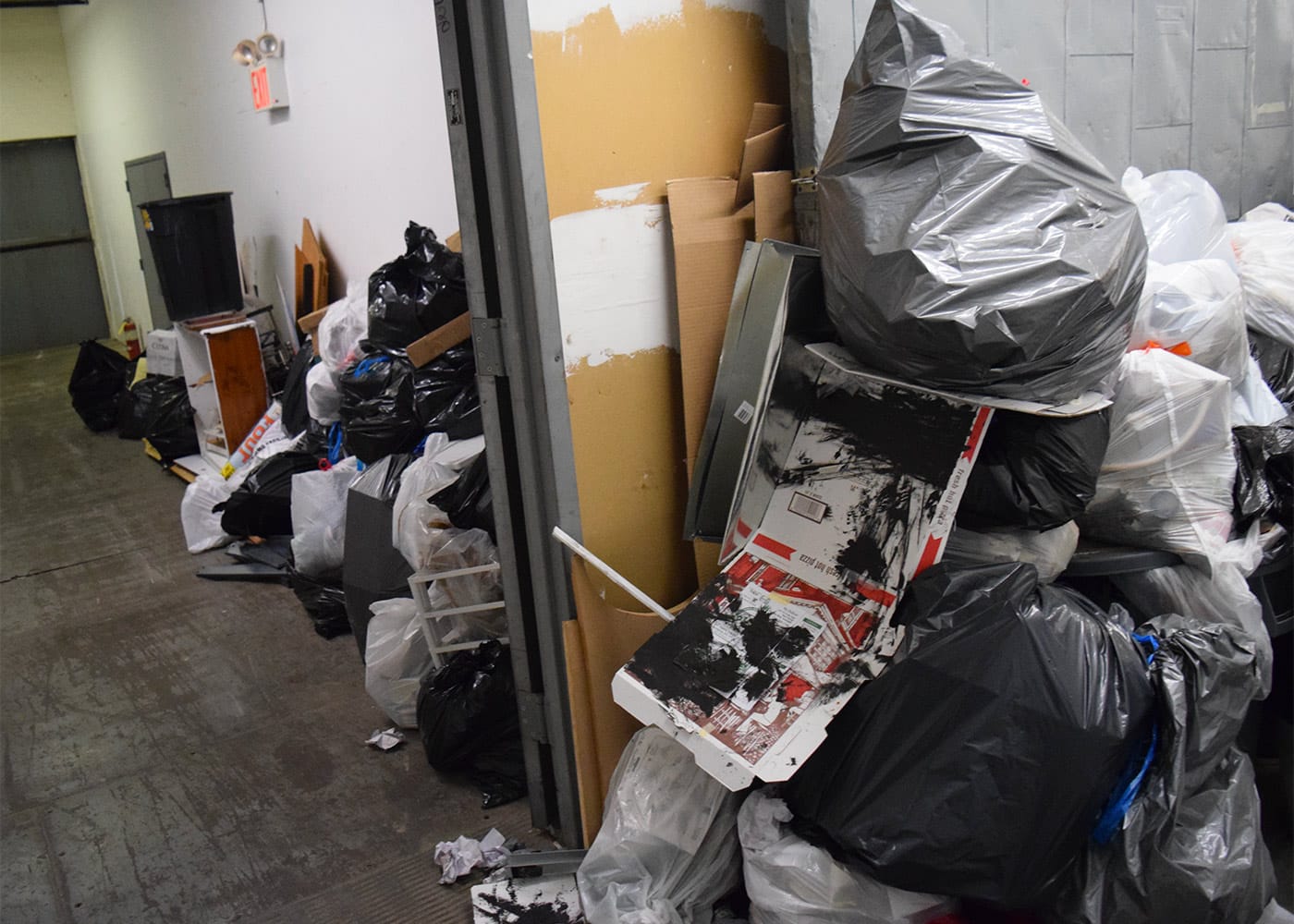 Trash fills a hallway at 112 2nd Avenue in Gowanus