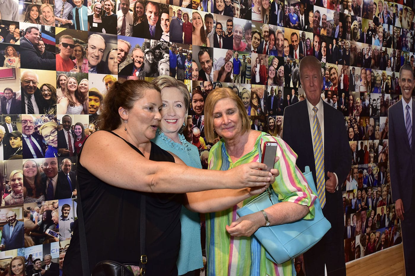 Visitors to the exhibition taking selfies with a life-size cutout of Hillary Clinton (image courtesy the International Center of Photography)