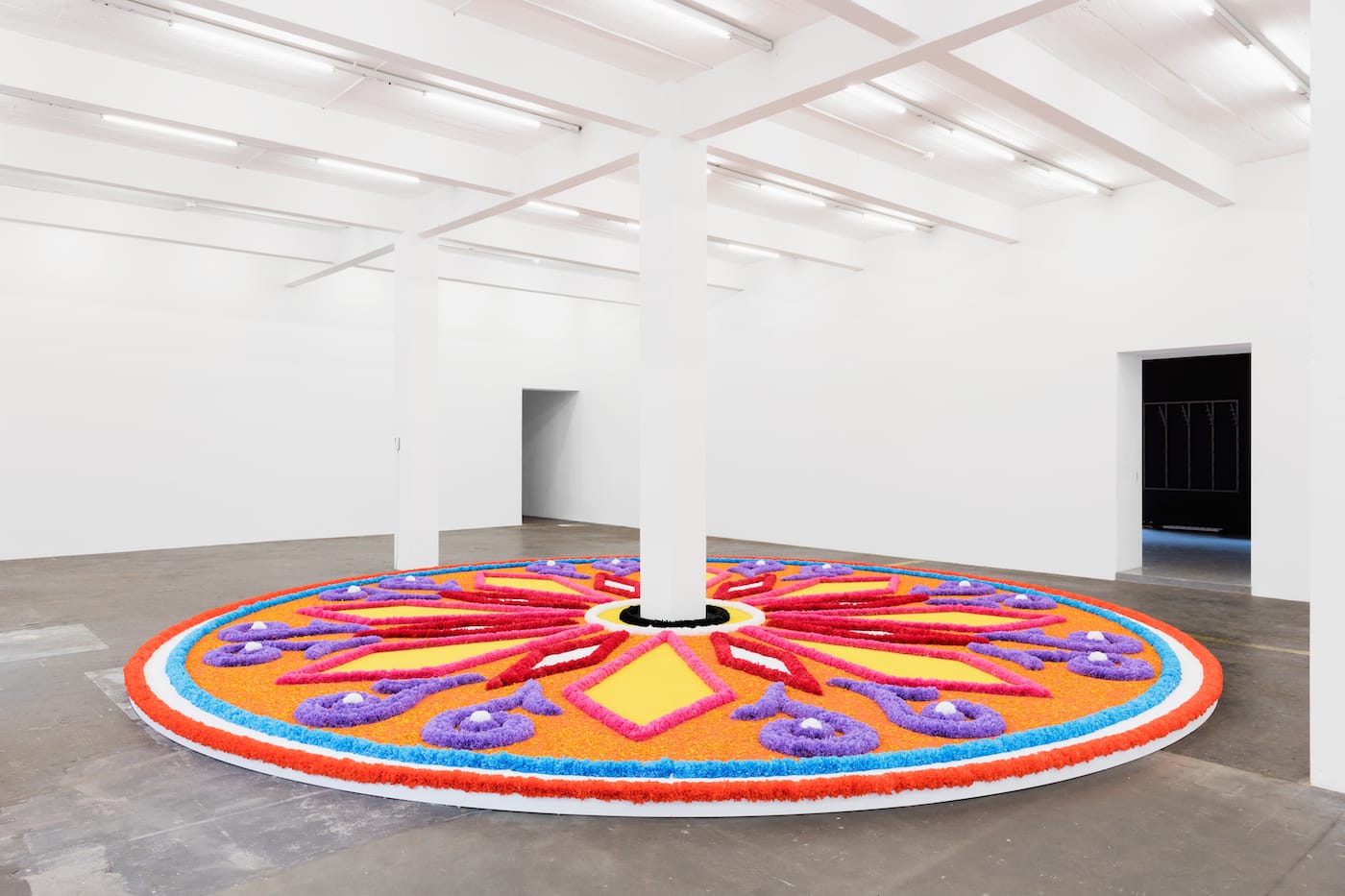 Jill Magid, "The Offering (Tapete de Flores)" (2016), artificial flowers, natural flowers, dyed sawdust, salt, glue; 20 ft in diameter (photo by Photograph by Stefan Jaeggi for Kunst Halle Sankt Gallen;courtesy of the artist; LABOR, Mexico City; RaebervonStenglin, Zurich; and Galerie Untilthen, Paris)