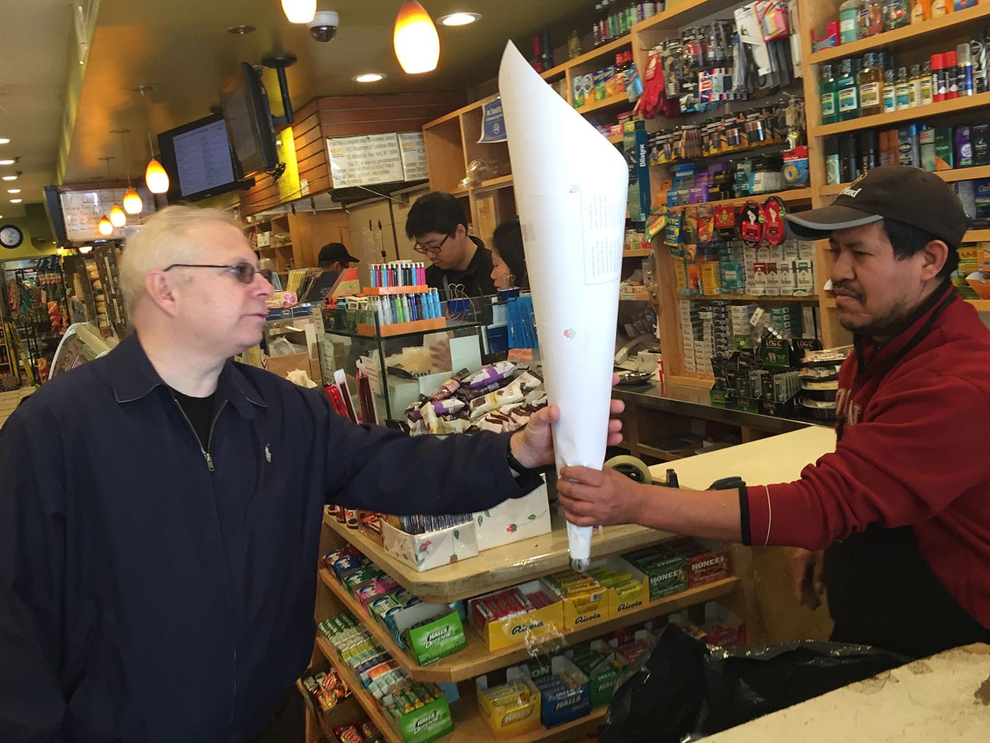 A customer buys flowers wrapped in Hewson's Fair Trade paper