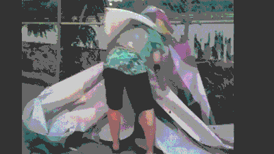 A suspect makes off with Kenny Scharf's "NEVERENDINGOGO" banner on August 2016. (GIF by the author via YouTube)