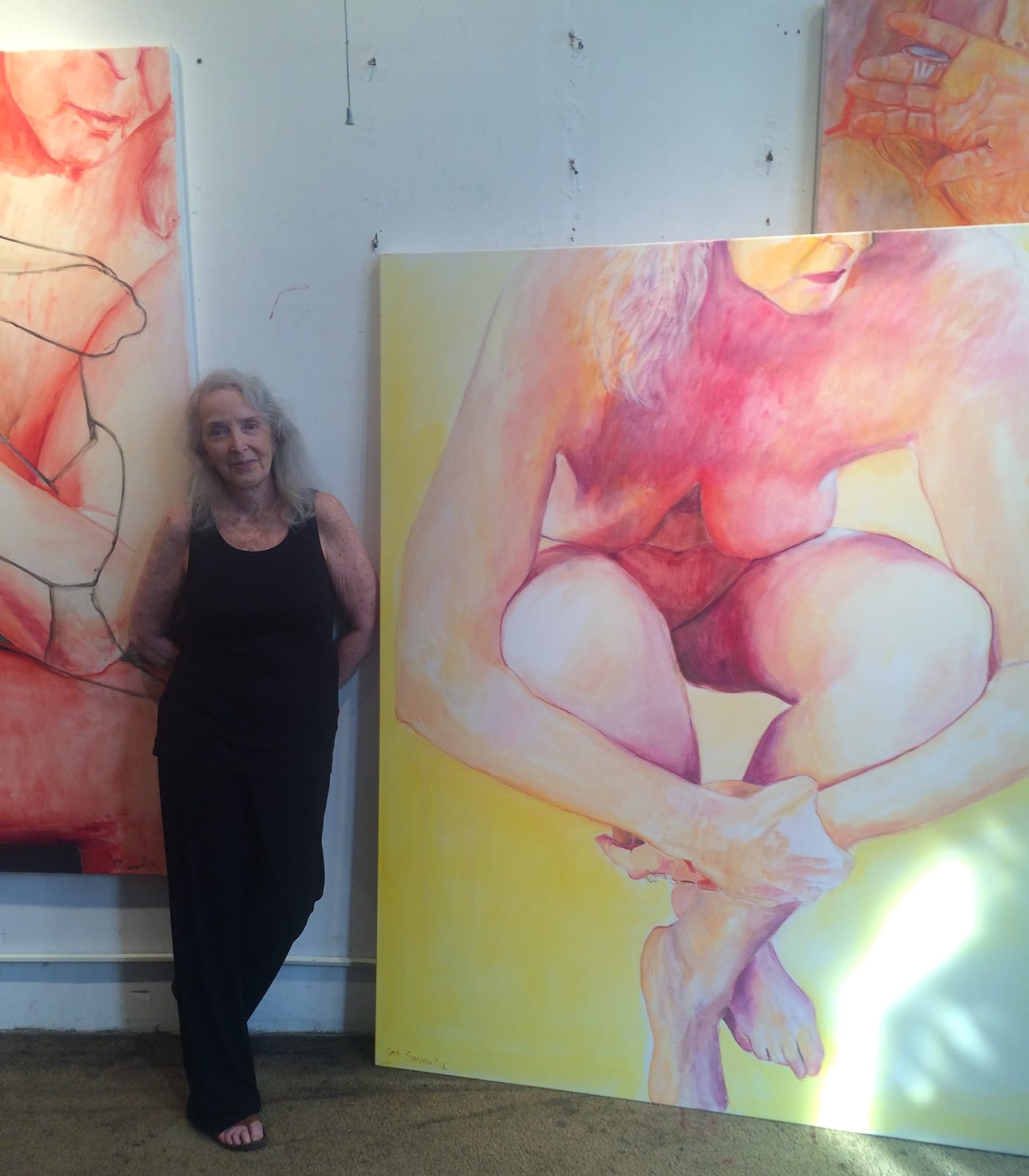 Joan Semmel in her studio alongside "Embrace" (2016) (photo by the author for Hyperallergic)