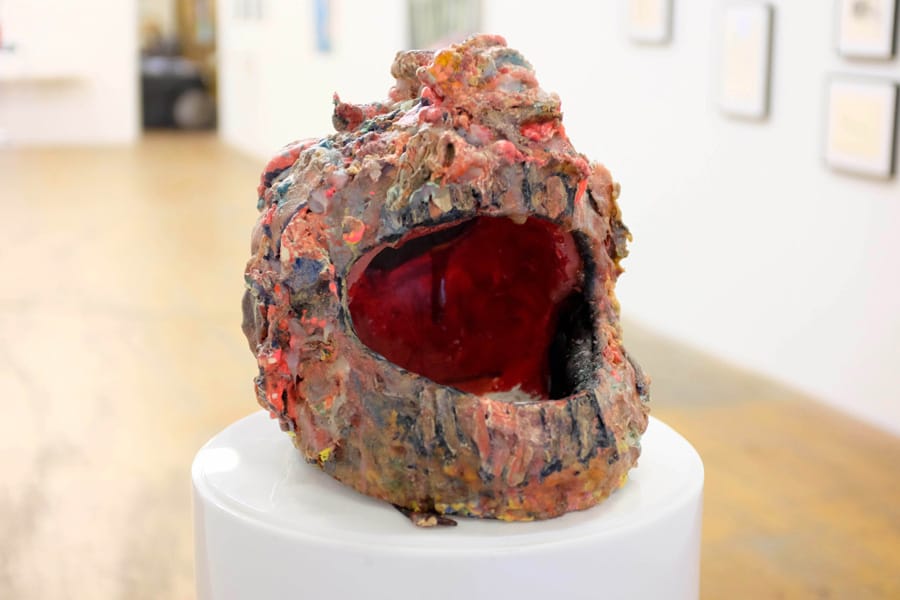 Aimee Goguen, "Face Hat" (2010), Gummy bears, balloons, crayon, acrylic, neon foam, plaster, plastic latex, sticks. (via one.usc.edu)