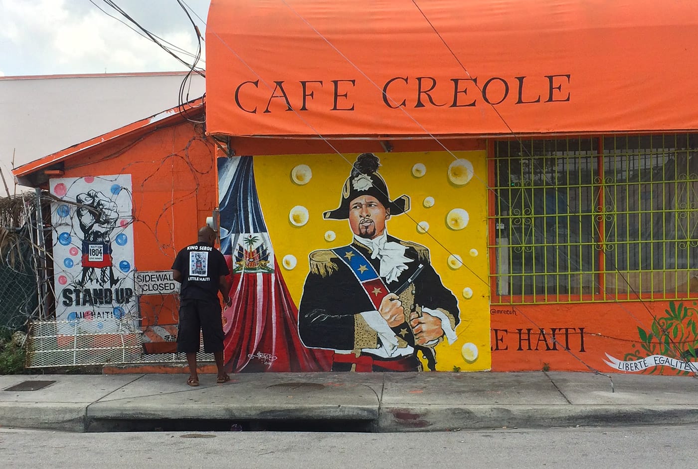 Serge Toussaint working on a mural in Little Haiti
