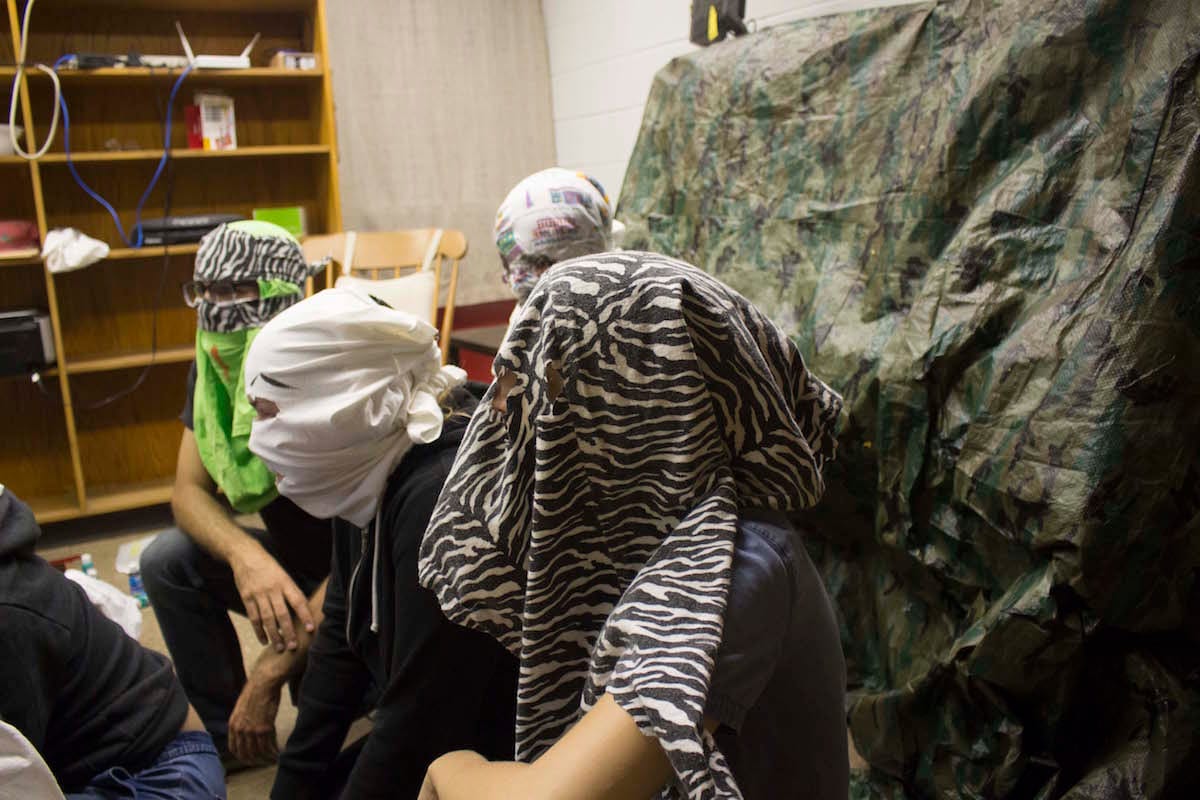 Masked participants as a part of the final section of Nick Wylie and John Paul Glover’s manual, “To The Seminal Edge: A Manual for 4-7 Revolution Seekers” 