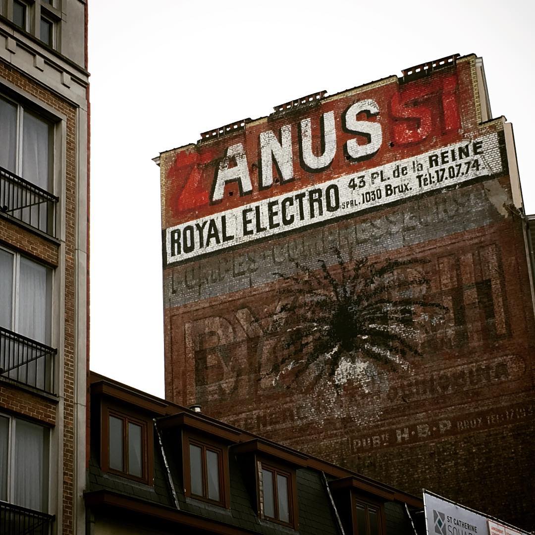 A mystery street artist's alteration to an old factory sign (photo by @debochavic/Instagram)