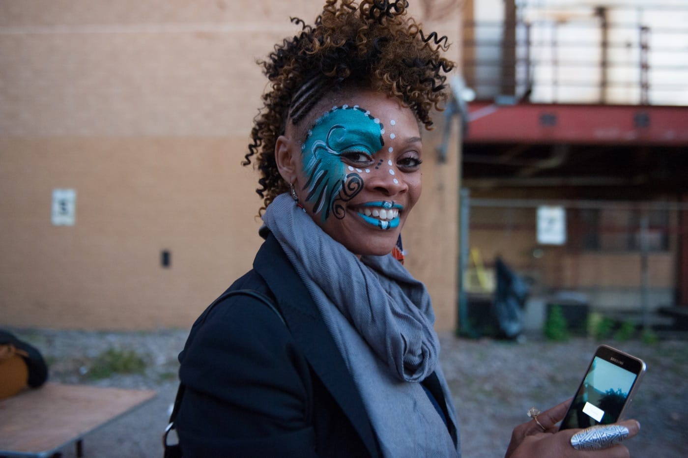 A visitor has her face fainted during the festivities