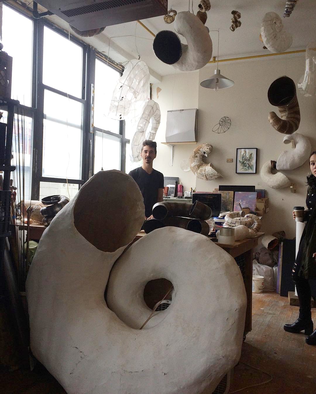 Paulapart amid their sculptures (photo by Claire Voon for Hyperallergic)