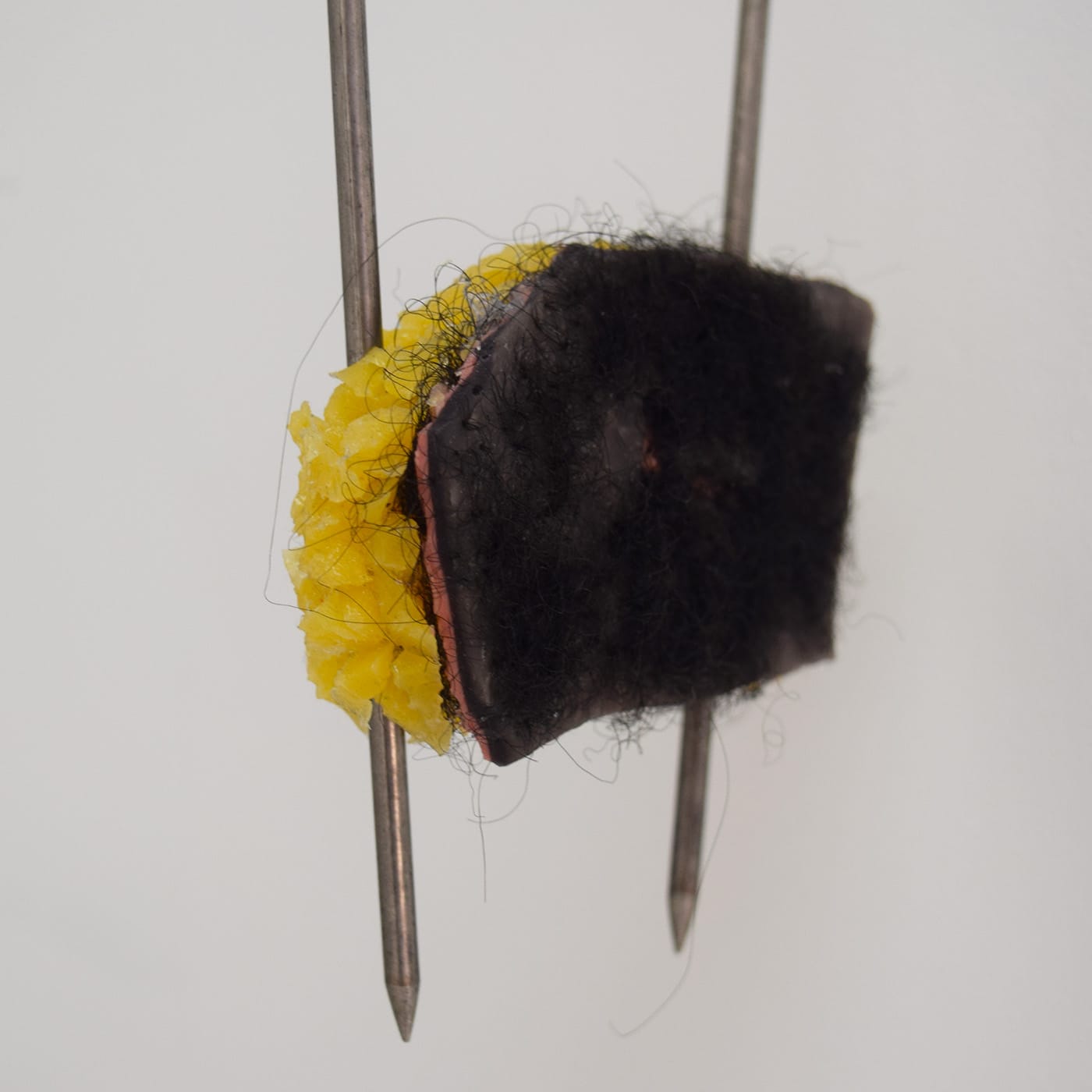 Doreen Garner, "Skin Sample" (2016, detail), steel hooks, silicone, hair weave, 18 x 4 x 1 in