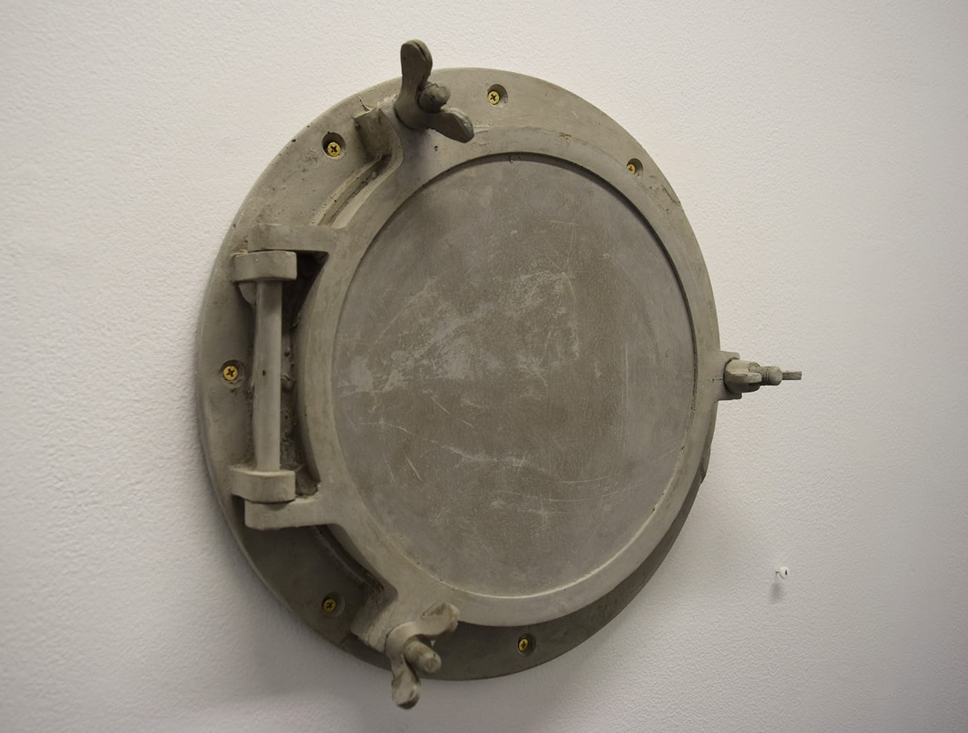 Christina Kelly and Amy Sohn, "Porthole" (2016), concrete cast of a porthole that was originally from a Navy rescue boat that was transformed temporarily into an art and sustainability boat on the Gowanus until it was abandoned, 13 in diameter