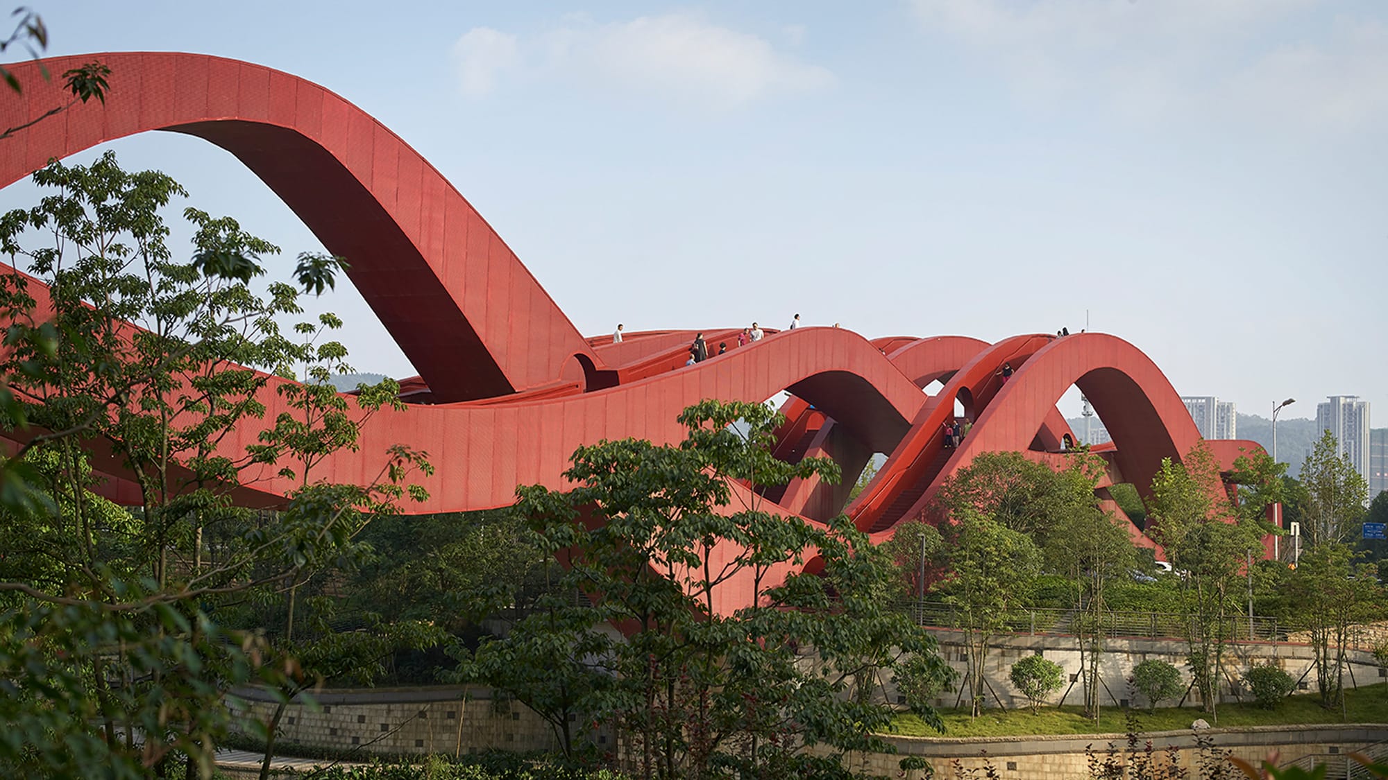 NEXT Architects has completed a wavy red footbridge in Changsha, China, that offers pedestrians a variety of different routes across the Dragon King Harbour River. (via Dezeen)
