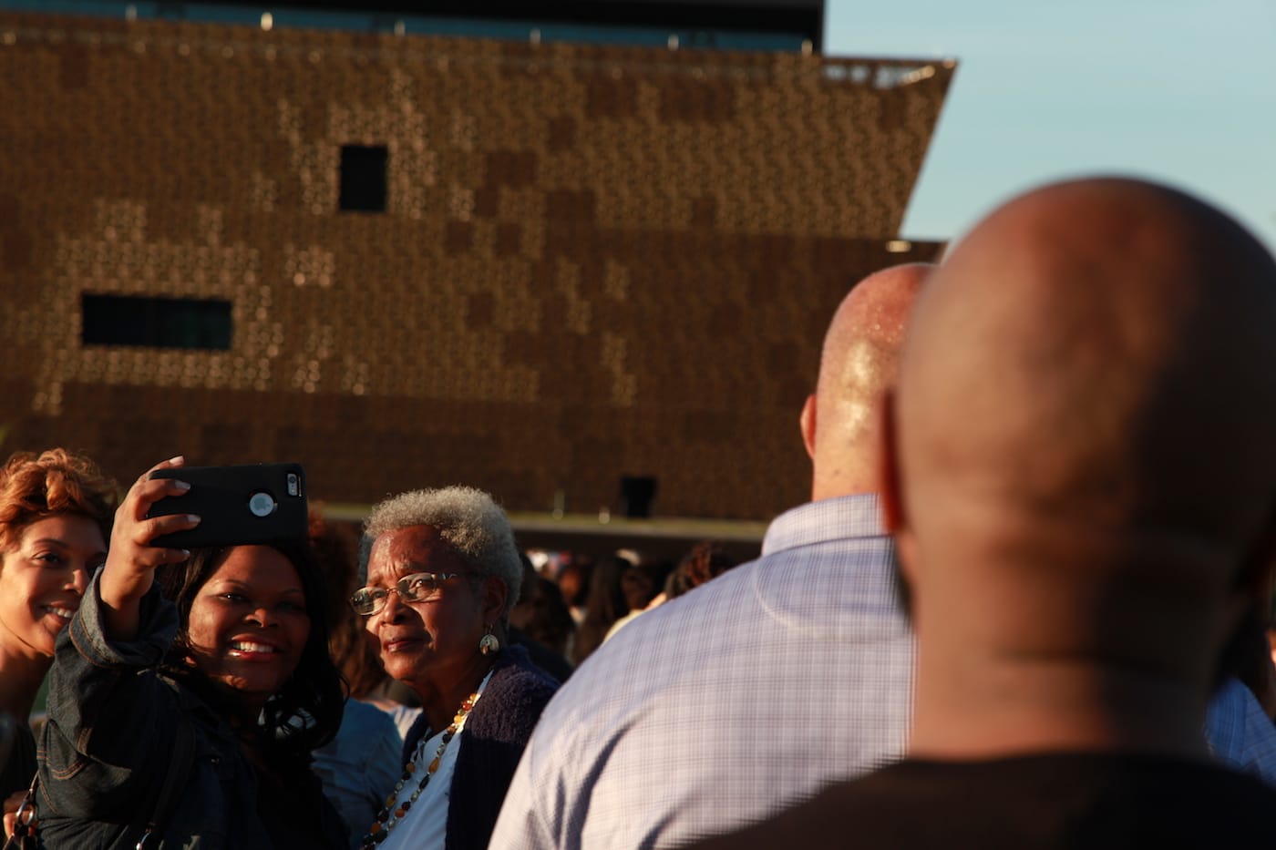 Visitors wait in line to get into the National Museum of African American History and Culture on opening weekend