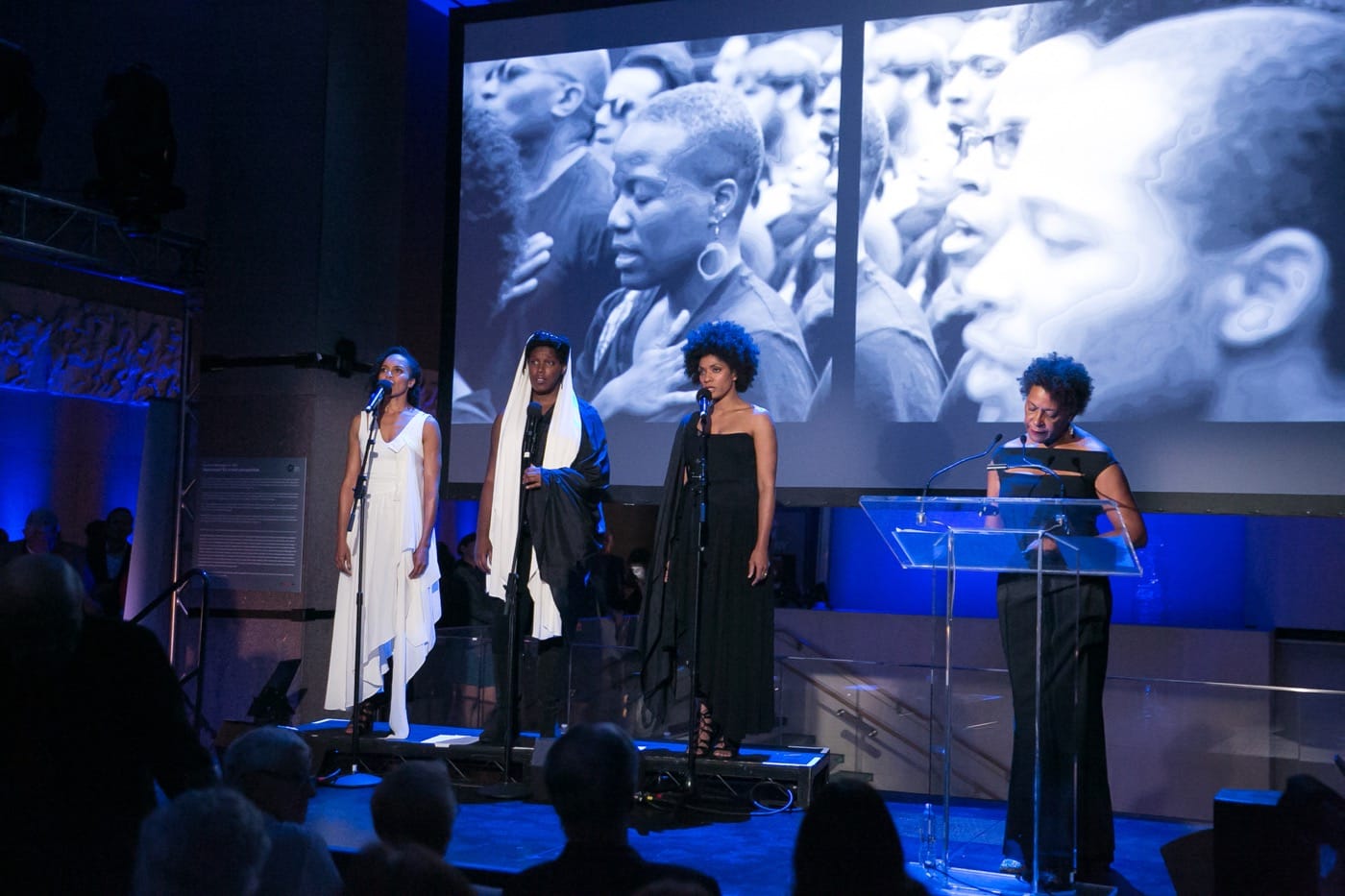 Carrie Mae Weems performing Past Tense with performers (from left to right) Eisa Davis, Imani Uzuri and Alicia Hall Moran, in a multi-media work incorporating song, text, projection and video, 2016.