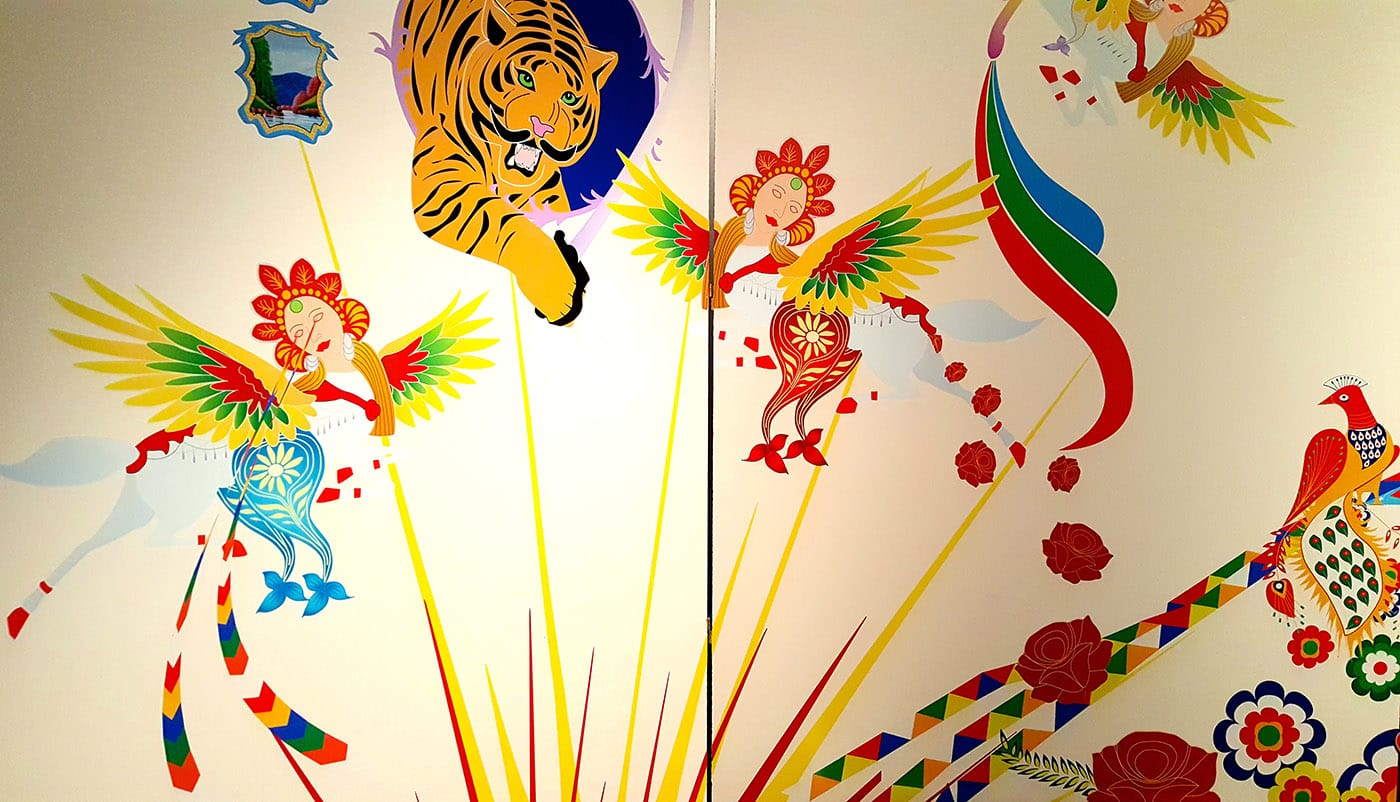 Detail from a wall mural using colorful Pakistani truck decals designed by Khan.