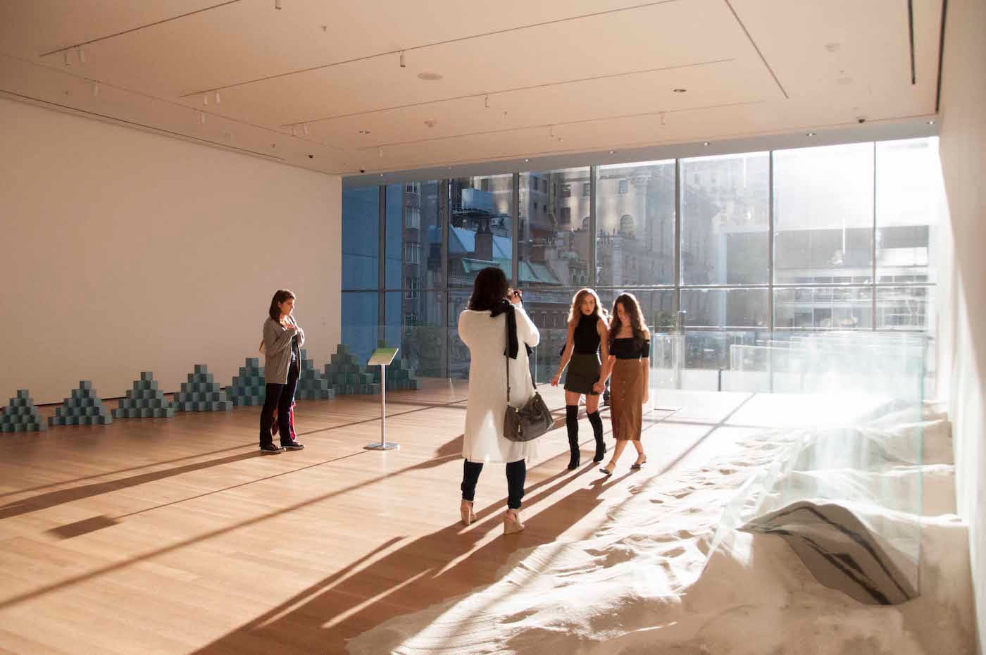 Visitors make their way downstairs to the meditation as sunlight streams through the windows of the Museum of Modern Art.
