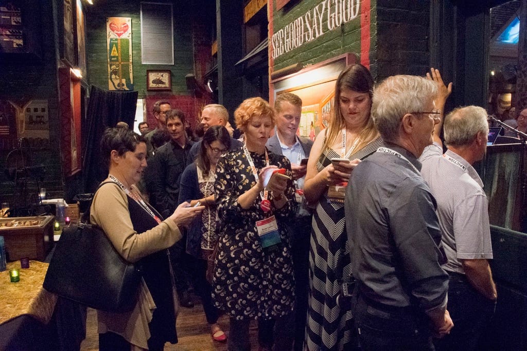 Two of the conference program co-chairs, Jennifer Foley (with black bag) and Suse Cairns (center, in patterned dress)