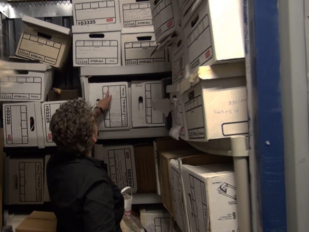 Filmmaker and COMPULSIVE PRACTICE co-curator Jean Carlomusto in her video archives preparing for Day With(out) Art 2016 (via moca.org)