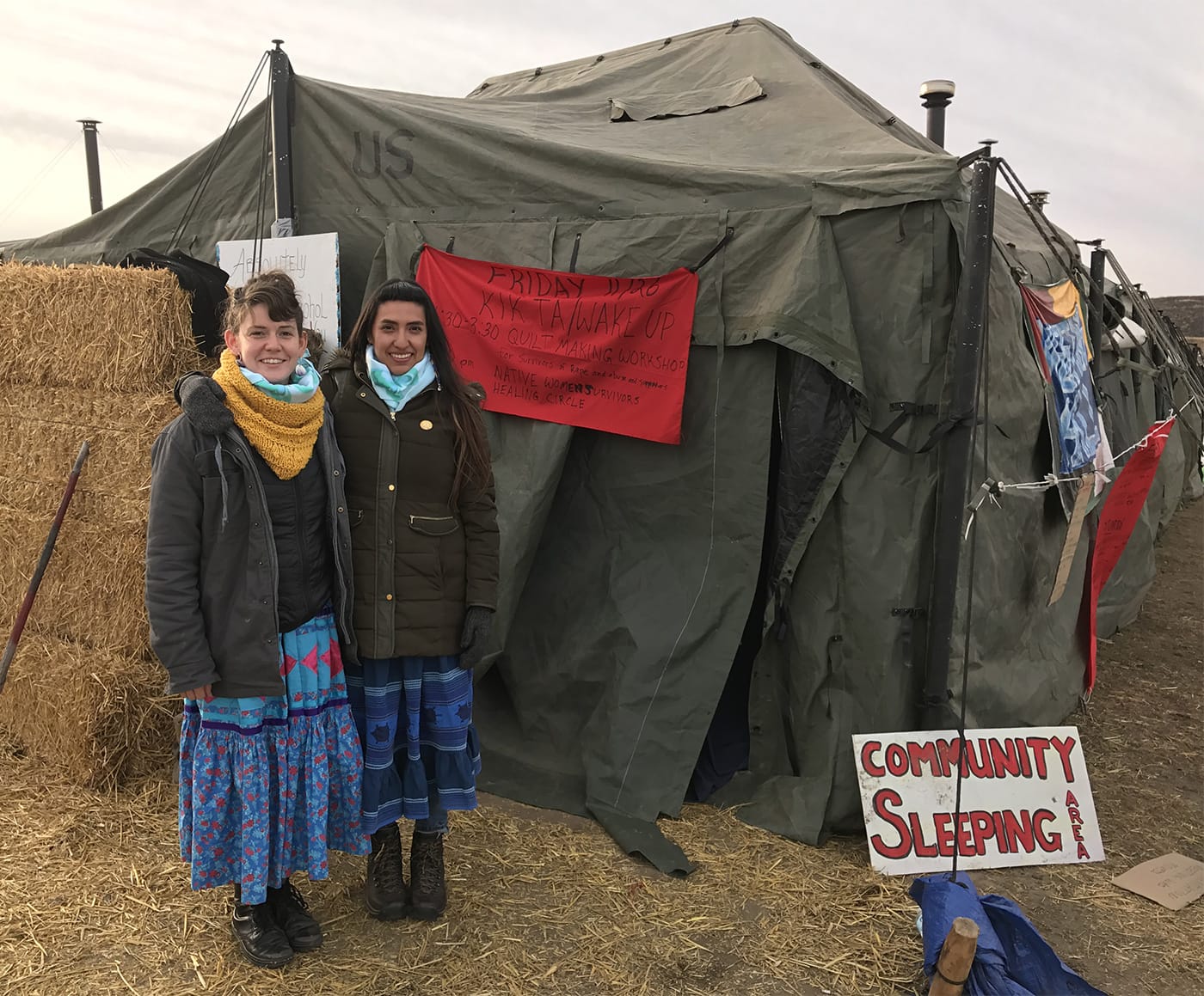 Artists Rebecca Nagle and Graci Horne by the tent they are conducting their healing events.