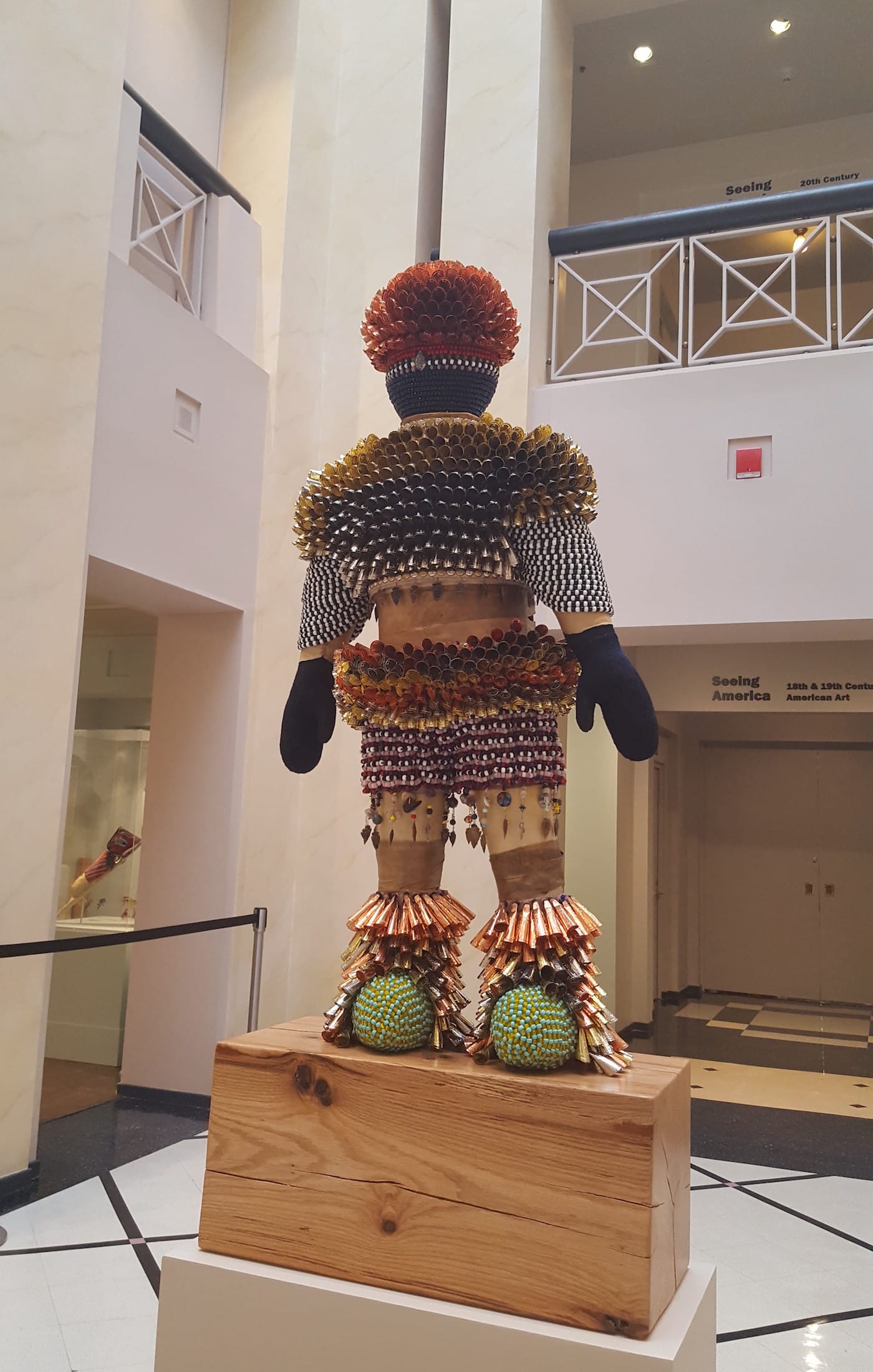 Jeffrey Gibson, "Come Alive! (I Feel Love)" (2016), acrylic felt, rawhide, wood, glass beads, stone arrowheads, steel wire, assorted beads, tin and copper jingles, artificial sinew, acrylic paint, druzy quartz crystal, steel and brass studs, 66 1/4 x 28 x 15 in, collection of the Newark Museum (photo by the author for Hyperallergic, work © Jeffrey Gibson)