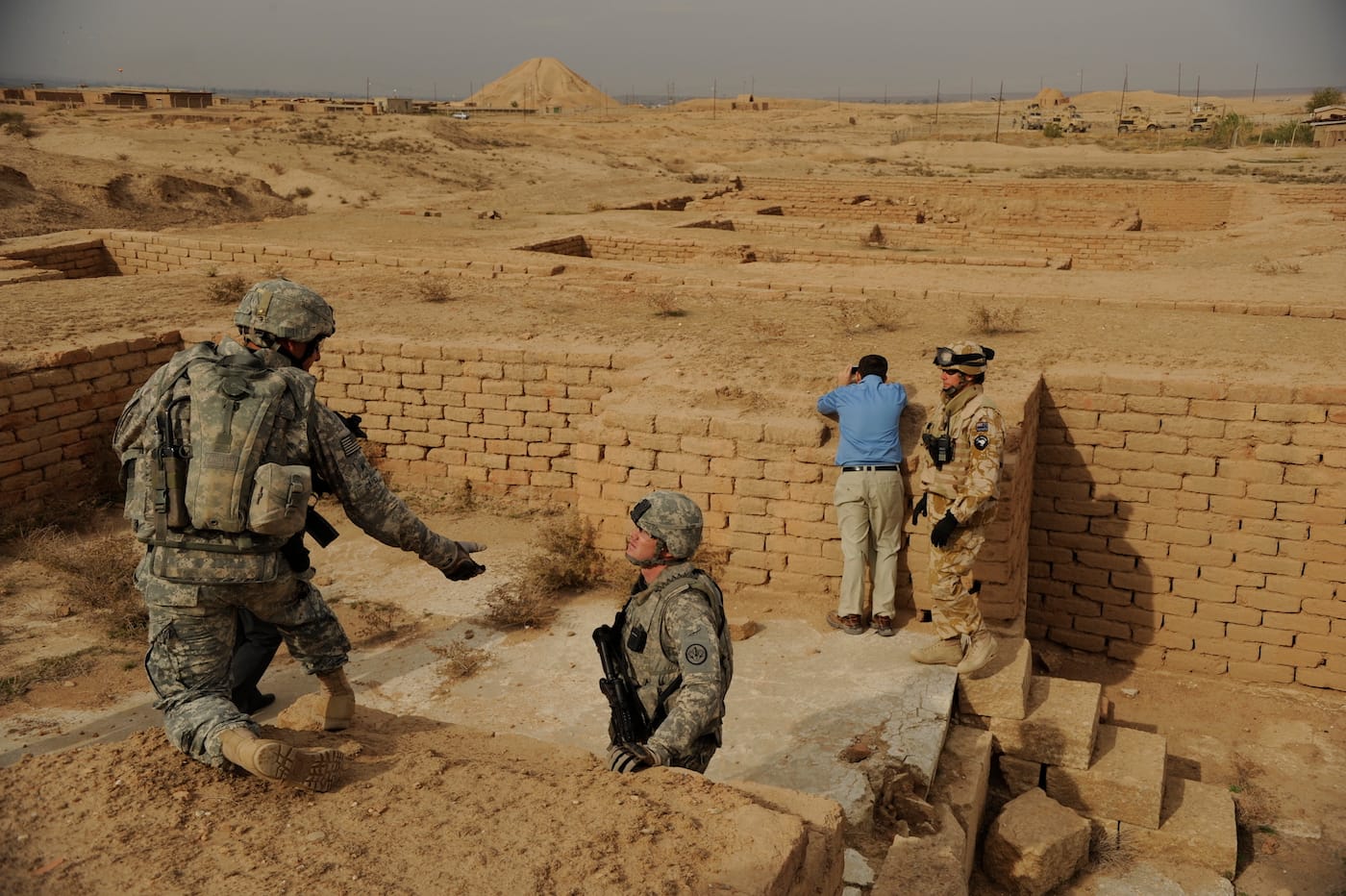 Members of the Provincial Reconstruction Team and UNESCO representatives visit Nimrud, whose ziggurat looms in the distance, in 2008. (photo by Staff Sgt. JoAnn Makinano, via Wikimedia Commons)