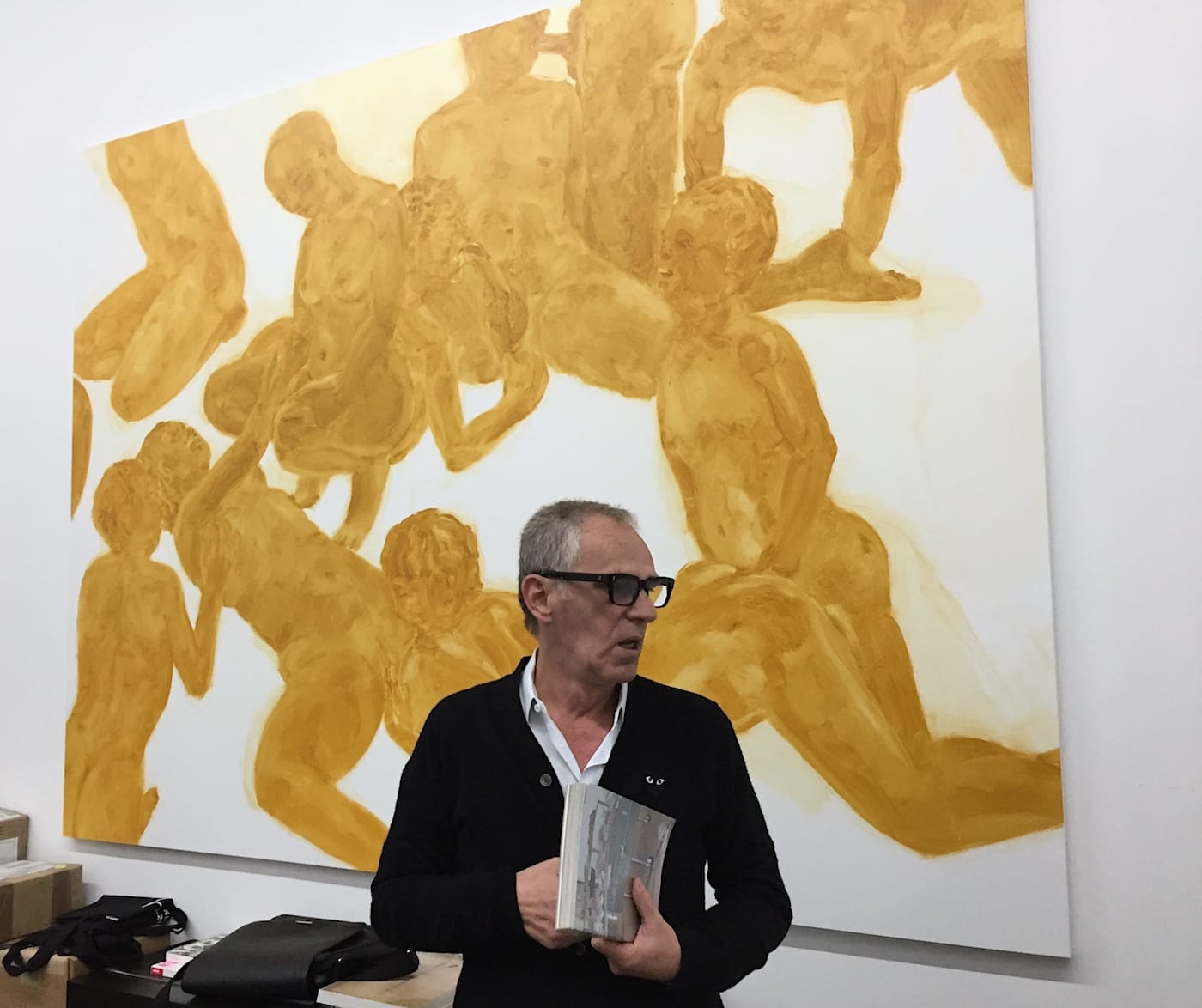 Mihai Nicodim in front of a painting by Philipp Kremer.