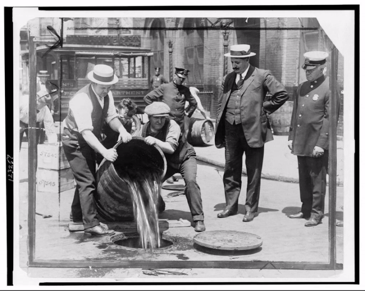 Liquor being poured down the sewer during Prohibition (courtesy Mob Museum)