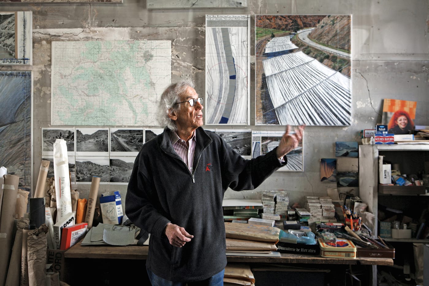Christo in his studio with a preparatory collage for "Over The River," 2011 (photo by Wolfgang Volz, © 2011 Christo)