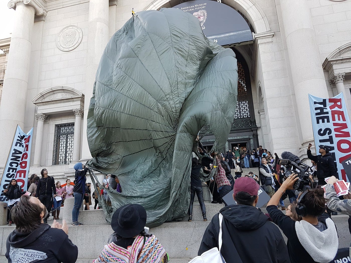 Decolonize This Place protesters at the American Museum of Natural History covering the Roosevelt statue