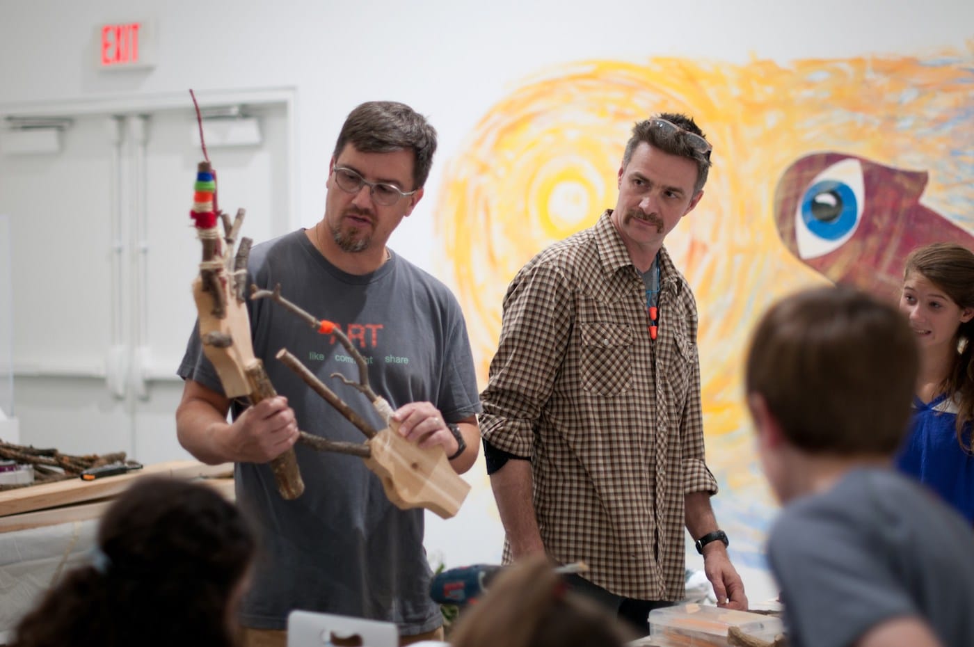 Matt Dehaemers and Mark Cowardin lead a demonstration with the M’Assim Tovim youth group during a repurposed wood and brush art-making workshop. (image Courtesy of the Epsten Gallery, Overland Park, KS)
