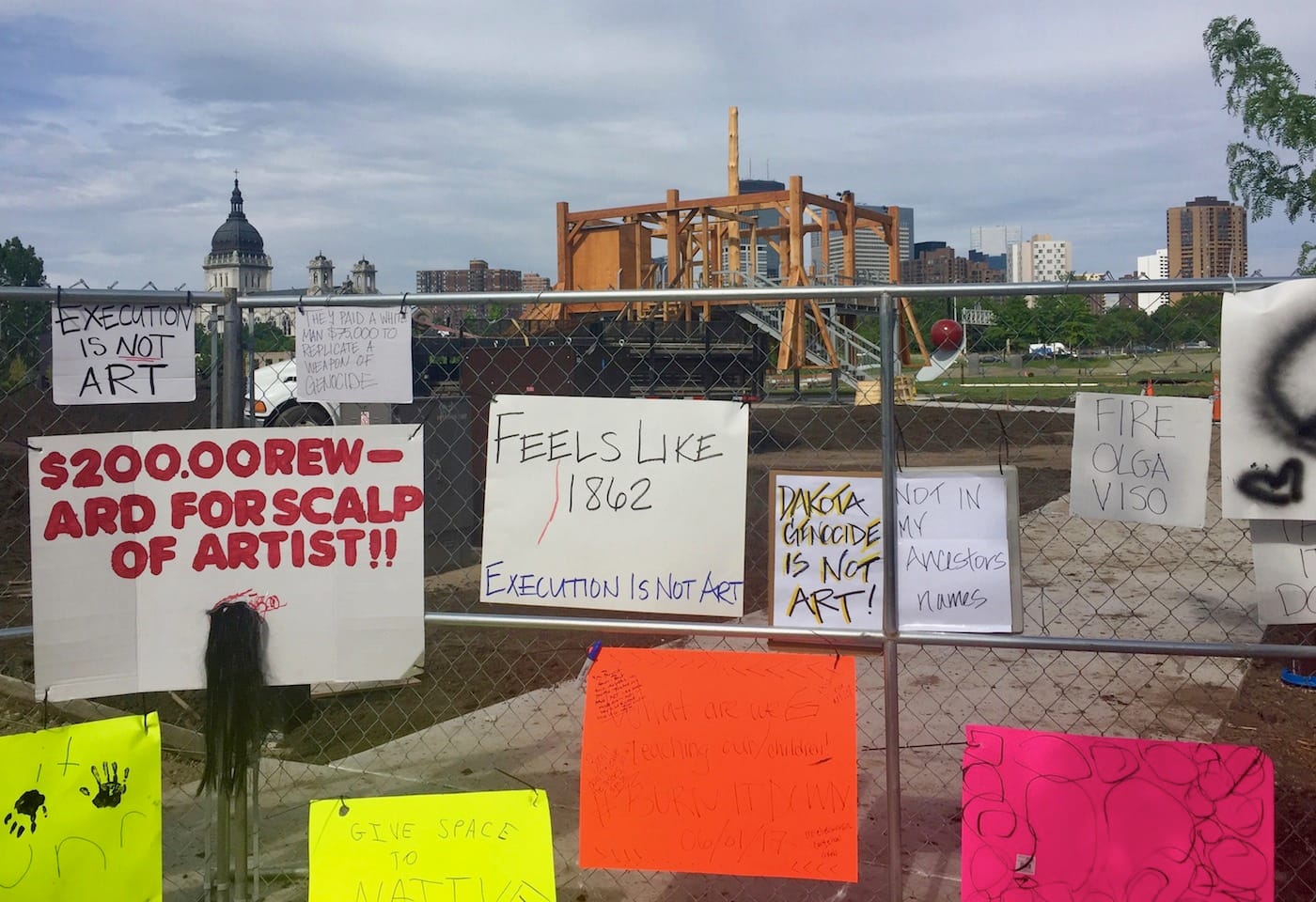 Protest signs on the fence near Sam Durant's "Scaffold" (2012) in the Minneapolis Sculpture Garden