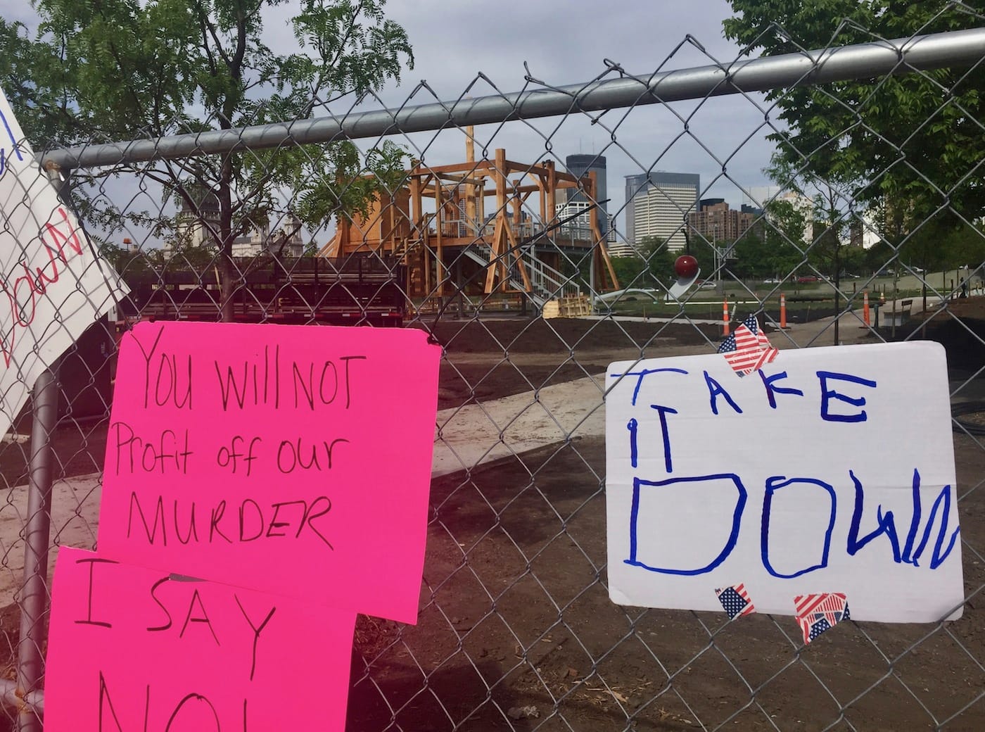 Protest signs on the fence near Sam Durant's "Scaffold" (2012) in the Minneapolis Sculpture Garden