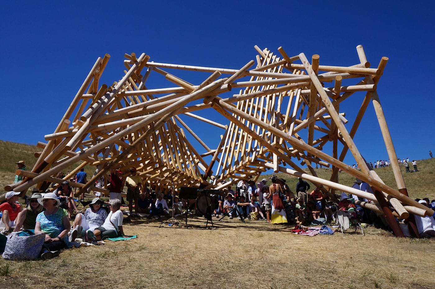 Audience members gathered under Stephen Talasnik’s “Satellite No. 5: Pioneer” (2015) at the Tippet Rise Art Center in Montana (photo by Jillian Steinhauer/Hyperallergic)