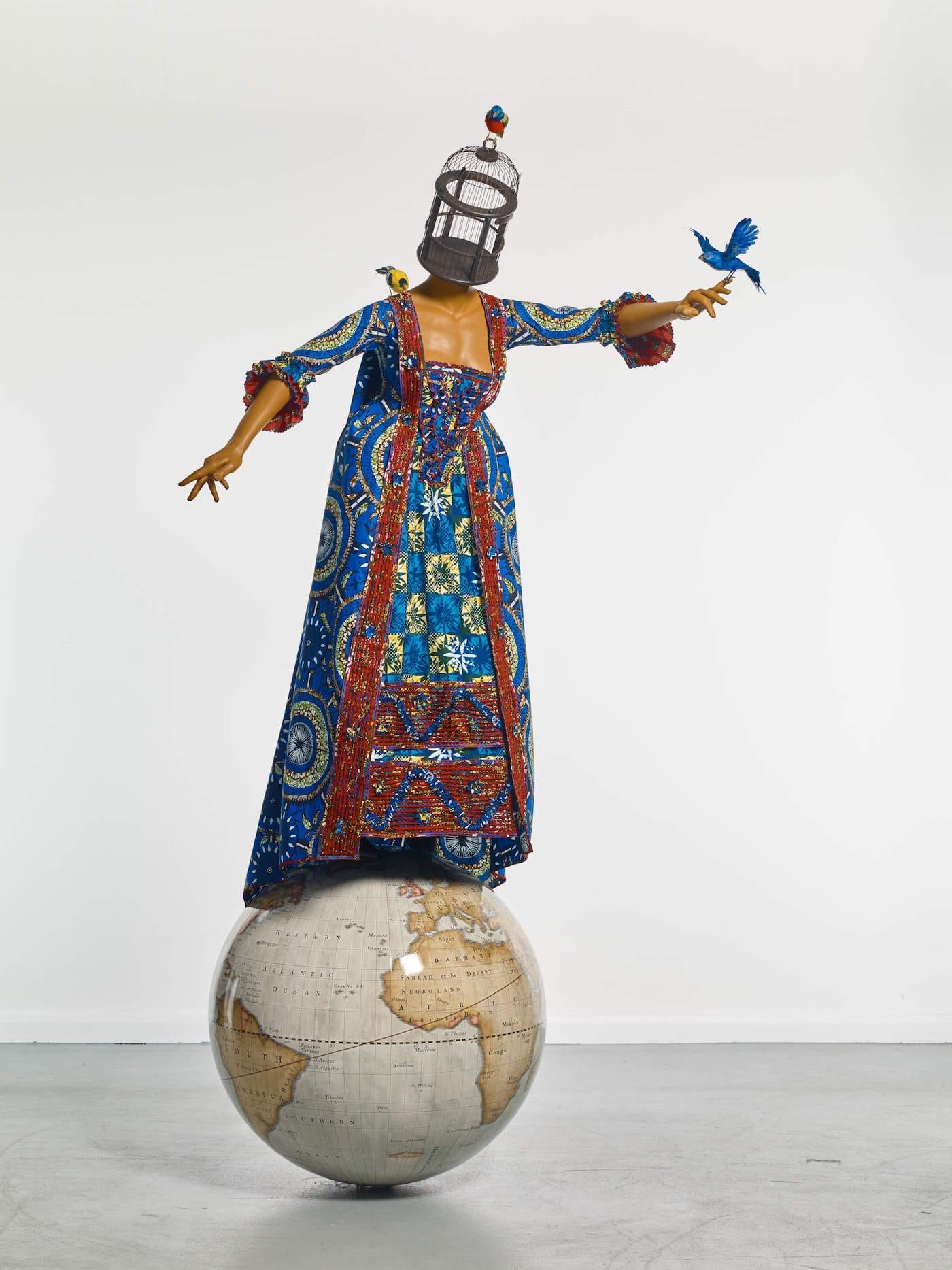 Yinka Shonibare MBE (RA), "Mrs Pinckney and the Emancipated Birds of South Carolina" (2017), fiberglass mannequin, Dutch wax-printed cotton textile, birdcage, birds, leather, and globe (courtesy Yale Center for British Art, photo by Stephen White)