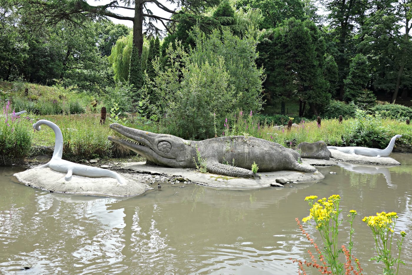 Dinosaur sculptures in Crystal Palace Park, London (photo by the author for Hyperallergic)