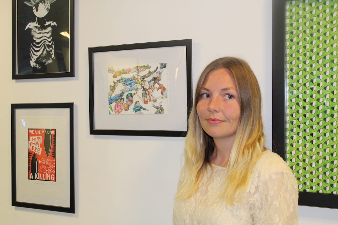 Art the Arms Fair co-organizer Amy Corcoran in front of her painting "Life and Death"