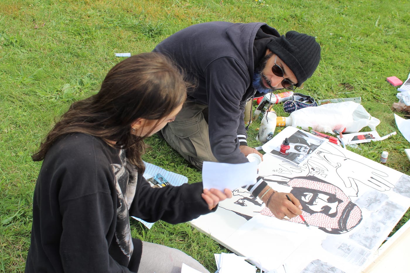 Iona Magnus and Bader Ben Hirsi creating a collaborative work outside DSEI 2017