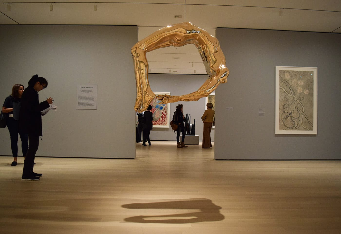 Installation view of Louise Bourgeois: An Unfolding Portrait at the Museum of Modern Art with "Arch of Hysteria" (1993), bronze, polished patina at center