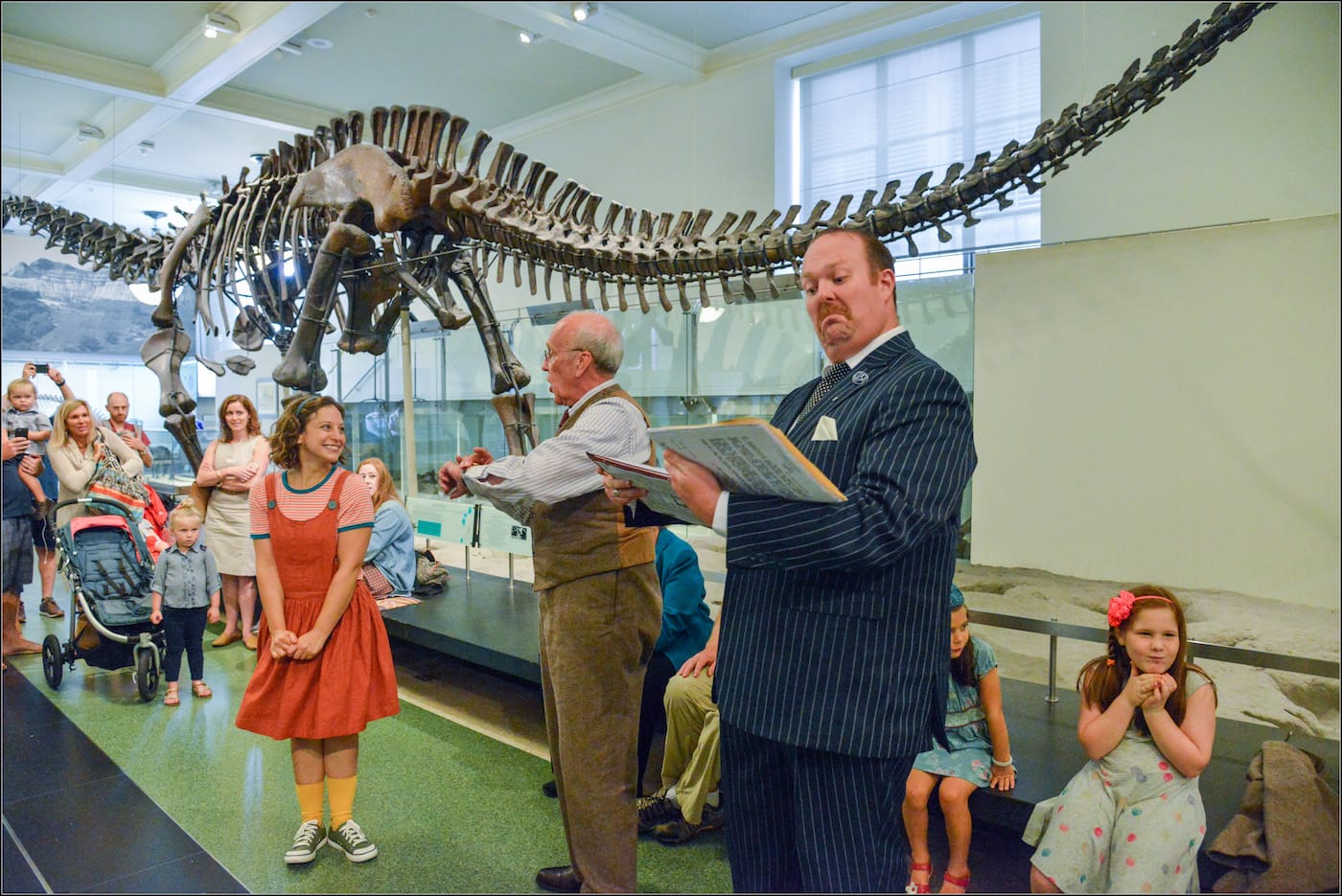 <em>Rhoda and the Fossil Hunt</em> in the Hall of Saurischian Dinosaurs at the American Museum of Natural History (photo by Shervin Lainez)