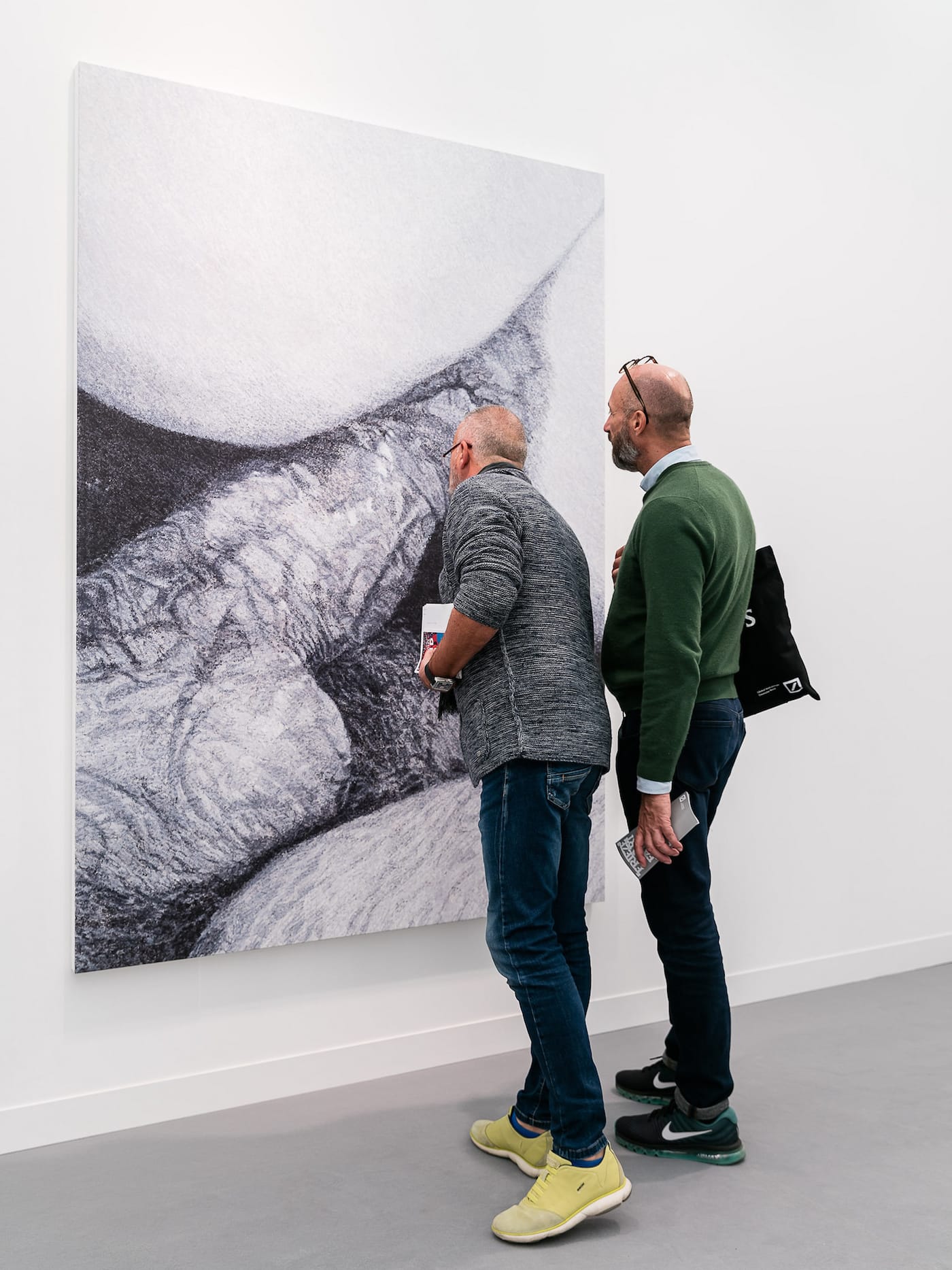 Visitors examine a painting by Betty Tompkins at Frieze London 2017 (photo by Mark Blower, courtesy of Mark Blower/Frieze)