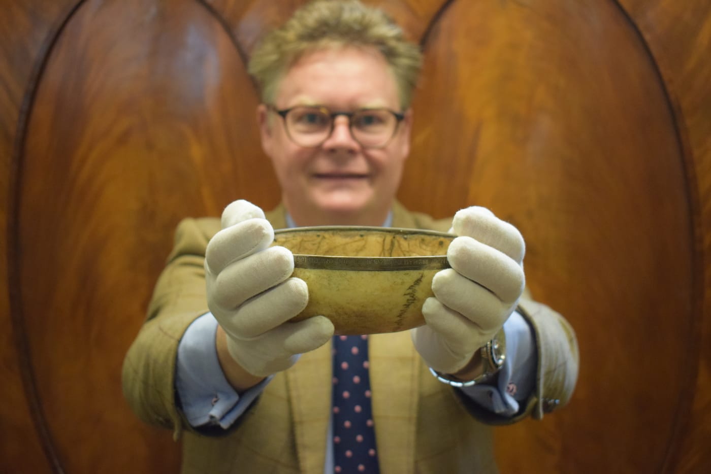 Auctioneer Richard Bromell with the skull drinking cup associated with Lord Byron (courtesy Charterhouse Auctioneers and Valuers)