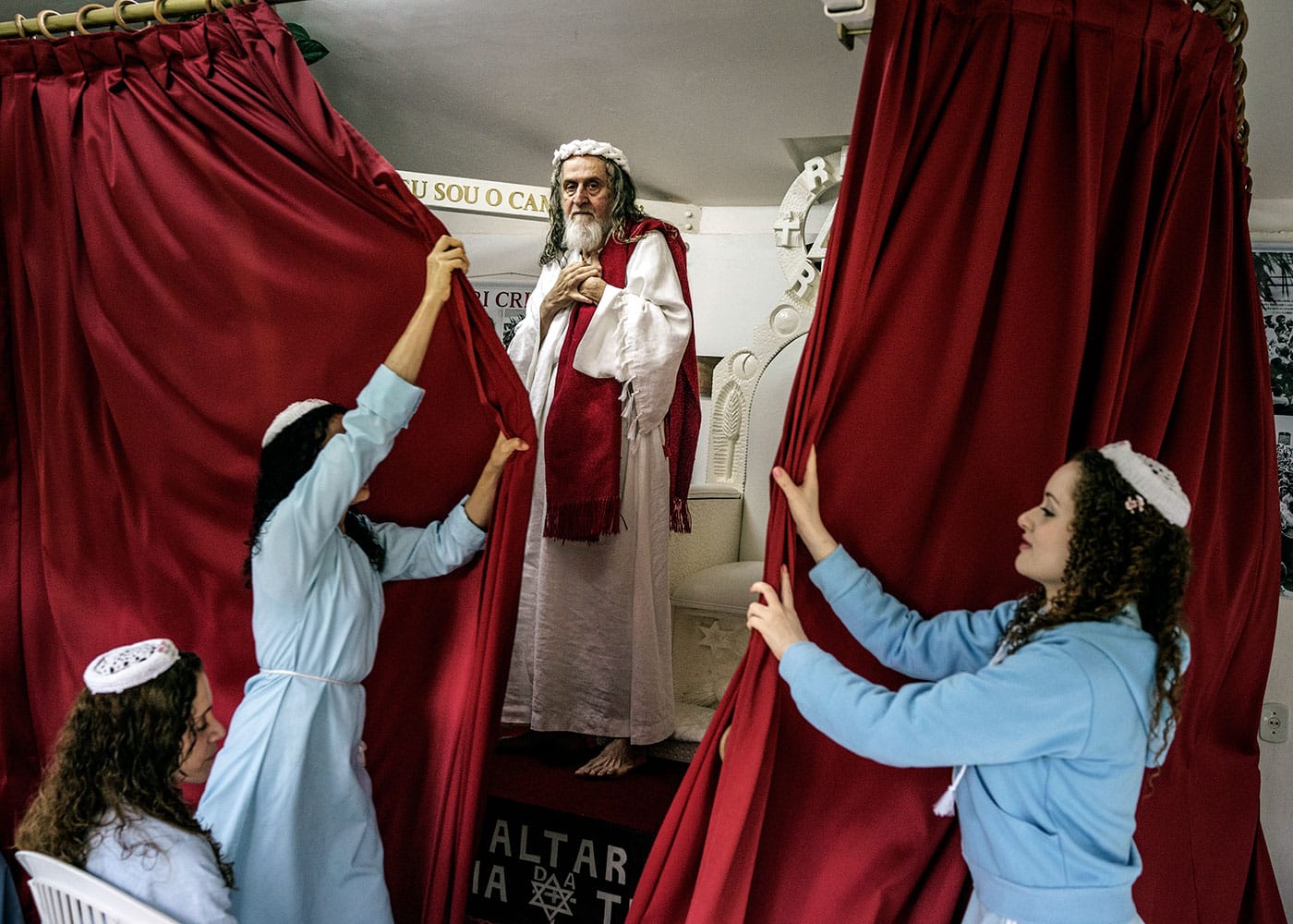 "In the compound chapel, disciples shut the curtains in front of INRI Cristo after he has delivered the sermon of the day." (Brazil, 2014), photograph by Jonas Bendiksen from <em>The Last Testament</em> (courtesy Aperture, © Jonas Bendiksen/Magnum Photos)