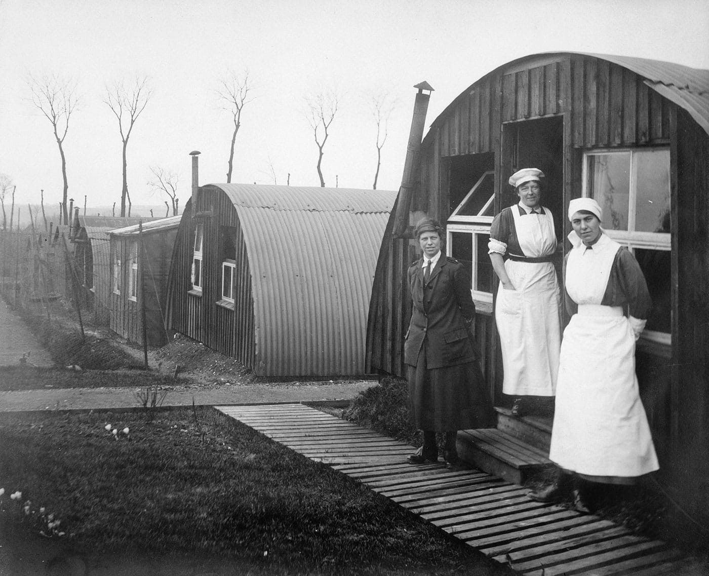 Olive Edis, "Commandant Johnson and two other women of the General Service Voluntary Aid Detachment (VAD) Motor Convoy outside Nissen Huts, Abbeville, France" (1919) (© IWM (Q 8036))