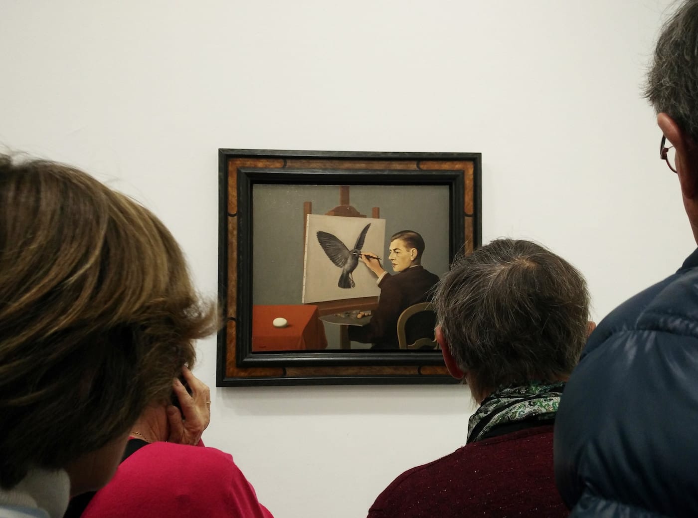 People viewing René Magritte's "La Clairvoyance" (1936) at the Pompidou in Paris (photo by Elide/Flickr)