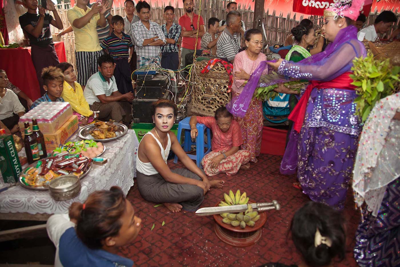 "A novice nat kadaw preparing to assist their teacher at a nat pwe in Mandalay. Ancient swords are part of the ritual stories of the nats." (© Mariette Pathy Allen, from <em>Transcendents: Spirit Mediums in Burma and Thailand</em>, courtesy Daylight Books)